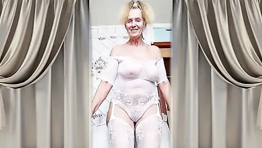 Hot housewife Lukerya flirts in an open transparent white jumpsuit in the kitchen 2