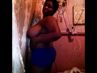 Chubby black woman shows her huge saggy tits