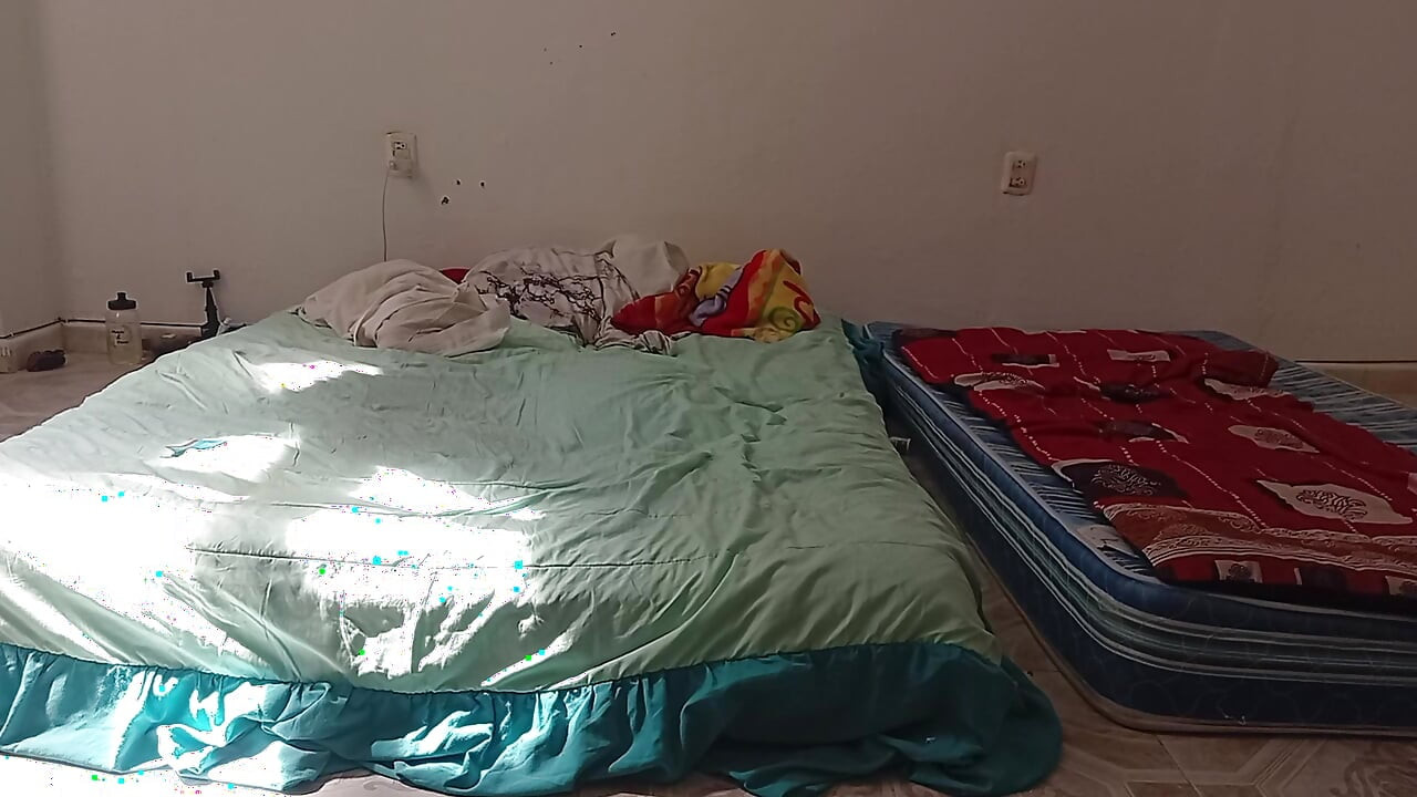 Mexican mother-in-law cleaning guest room in thong