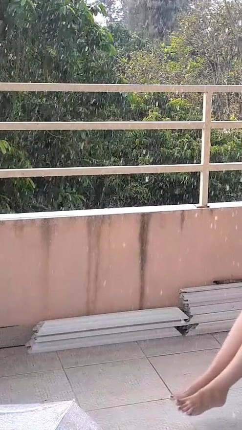 Cute lady is swinging on a hanging swing, hiding from the rain under an umbrella. 185 2 | Clip 1