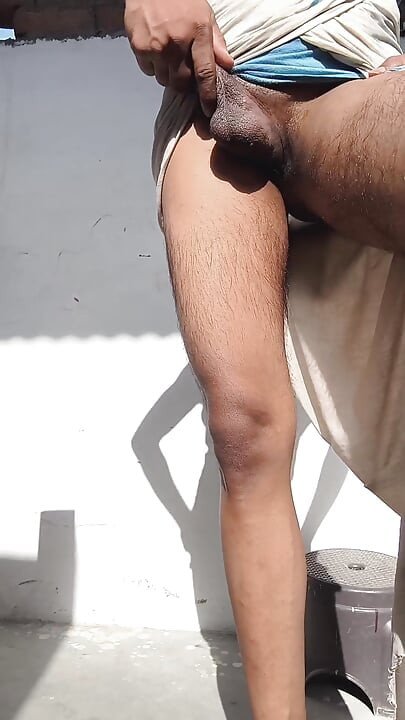 Young guy rubs his thick penis with oil