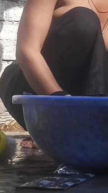 Emotional moment from "Indian stepsister is preparing to take a bath while washing clothes in the open courtyard of the house"