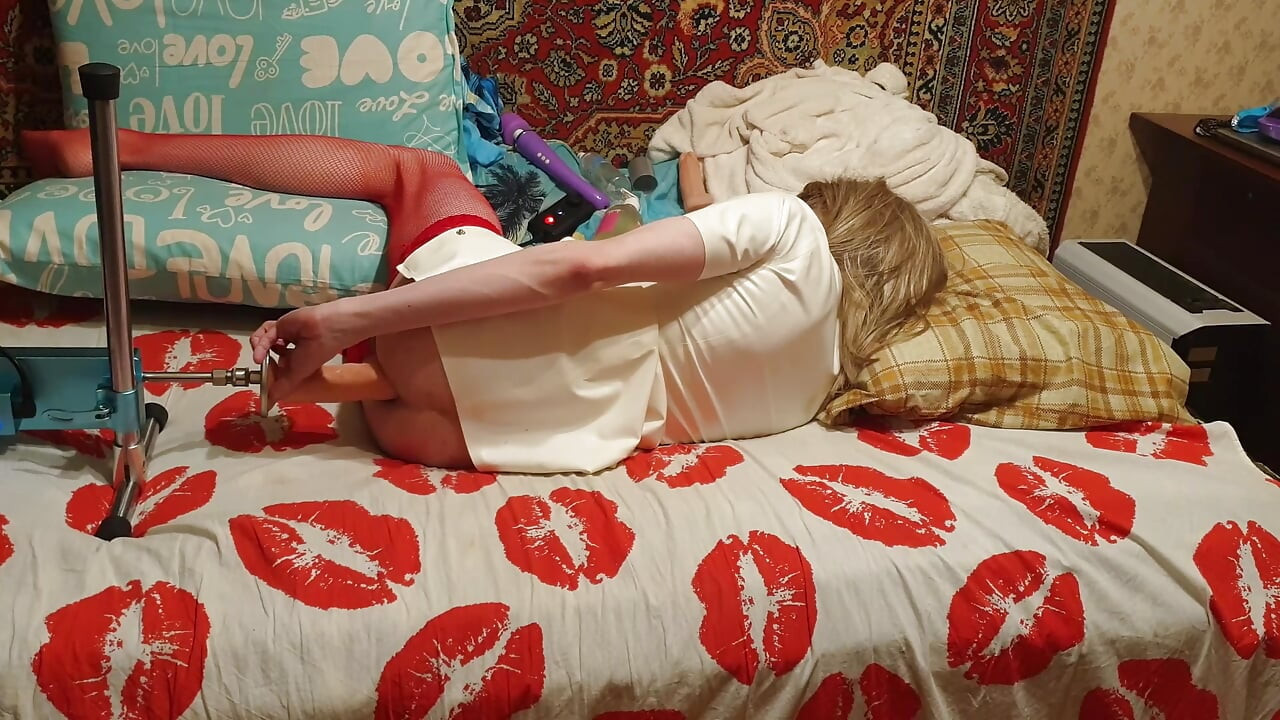 Tranny in latex nurse having sex with a anal dildo machine