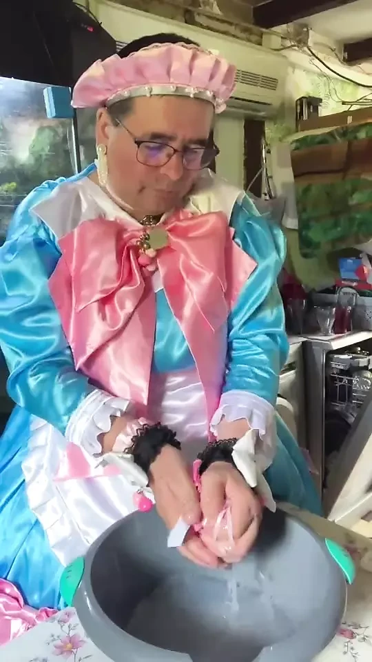 In a blue maid's outfit with pink bows to do the laundry.