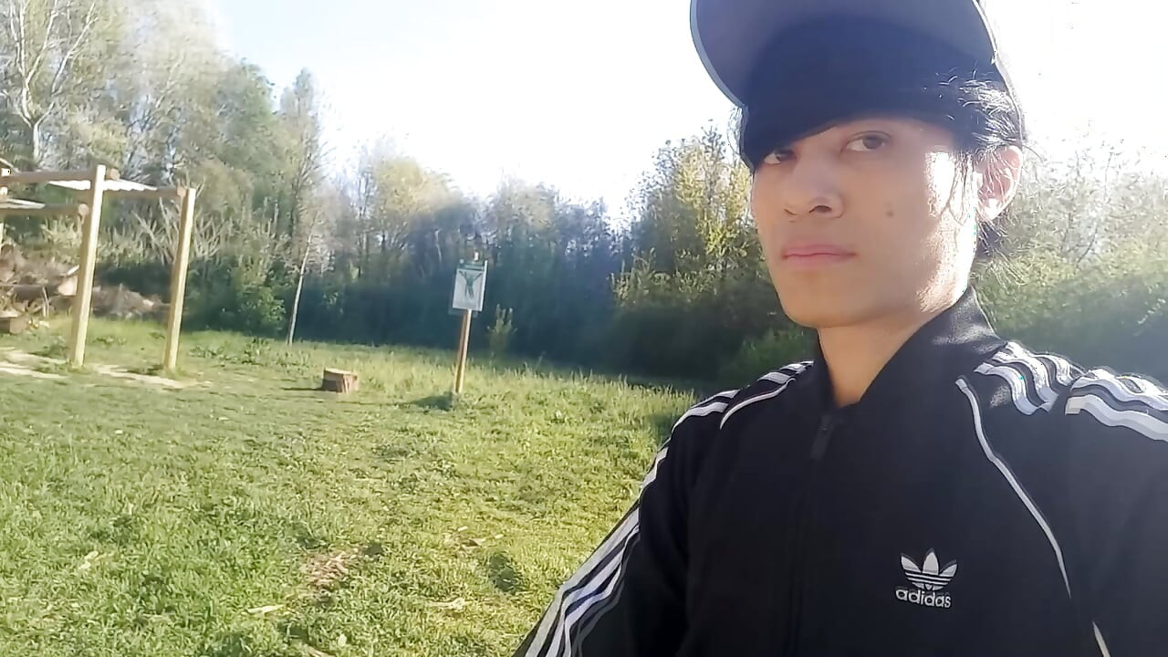Freeballing public twink walks outdoors commando no underwear beneath black Adidas tracksuit Campus sneakers while out cruising