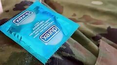 Jerking off in uniform into a condom already full of the cum of buddies