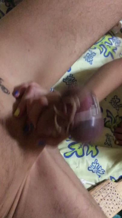 Submissive with stretched dick and balls, whipped at the same time."