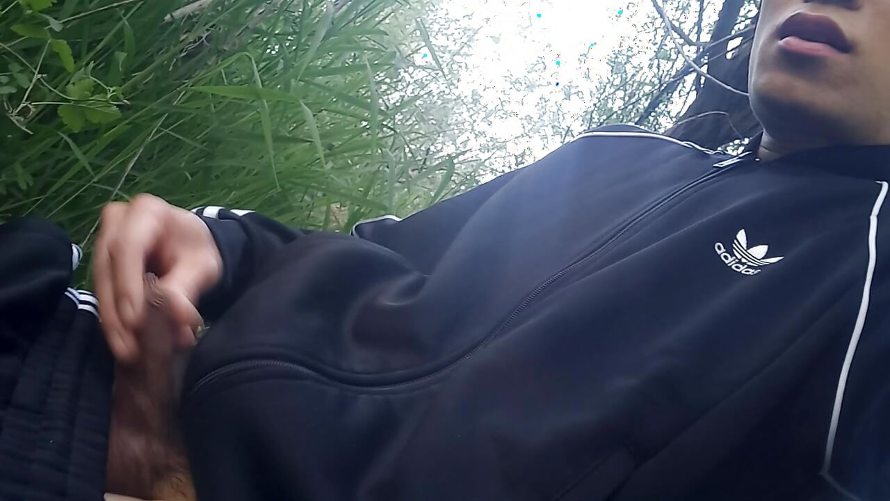 Gay boy Jon Arteen, wearing adidas tracksuit Campus sneakers, gets a hard-on outdoors, jerks off, squirts big cumshots before cl