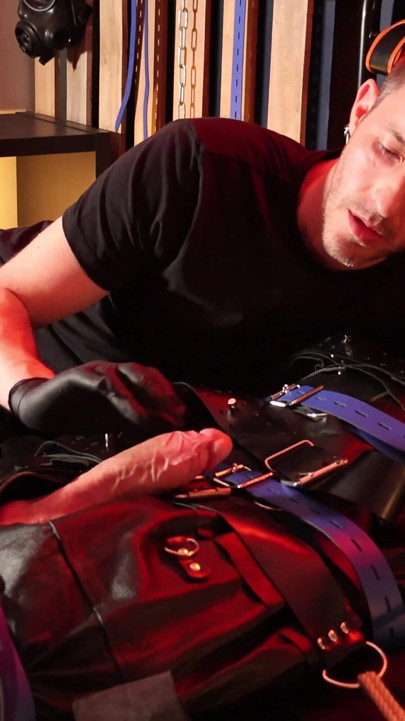 Edging the Boy in Leather Bondage but He Is Not Allowed to Orgasm