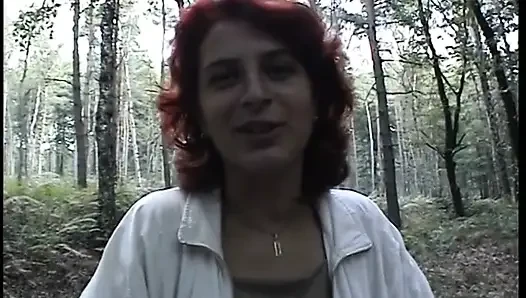 Redhead chick plays with her pussy outdoors