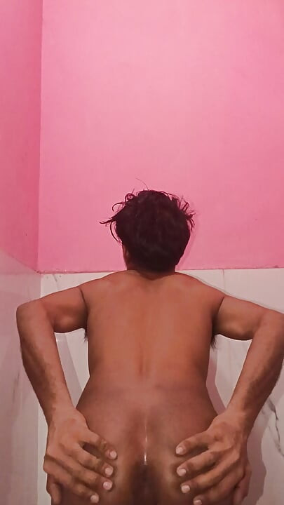 The boy is caressing his penis in the bathroom
