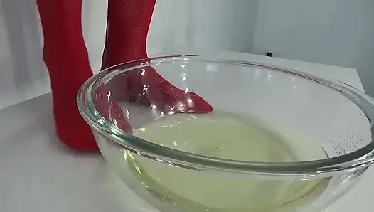 A MILF in Red Is Peeing Into a Basin.