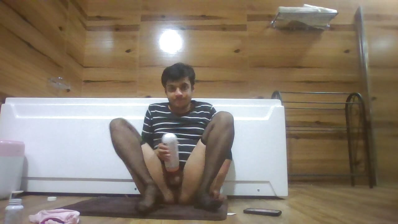 Sexy Sissy in Pantyhose Plays with Pocket Pussy while half naked and watching porn on her phone
