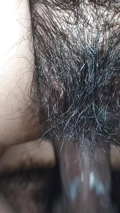 Close up view on a hairy and creamy pussy