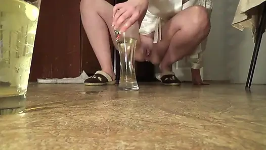 Sexy housewife in silk white robe desperating to pee long time and than pissing in  a glass