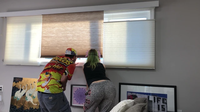 Couple Peeping Outside Apartment Window
