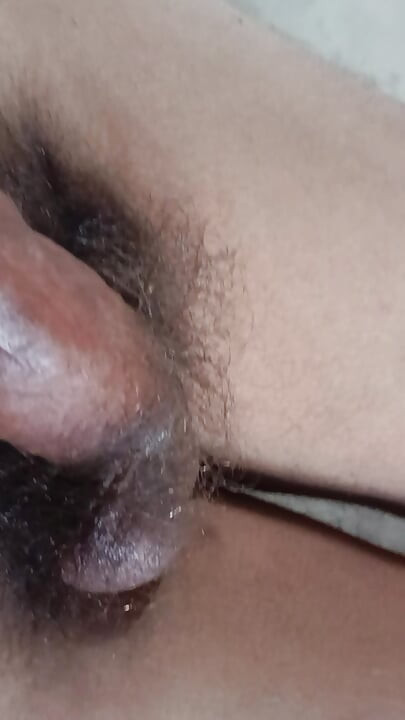The boy is shaking his penis in his hand and ejaculating.
