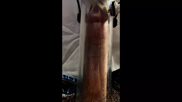 Milking machine sucks and stretches cock