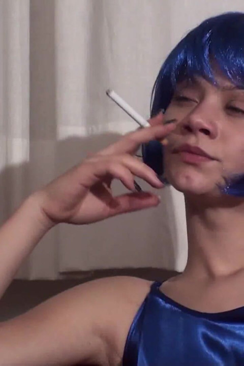 Colored hair beauty wearing lingerie and stockings smoking a cigarette