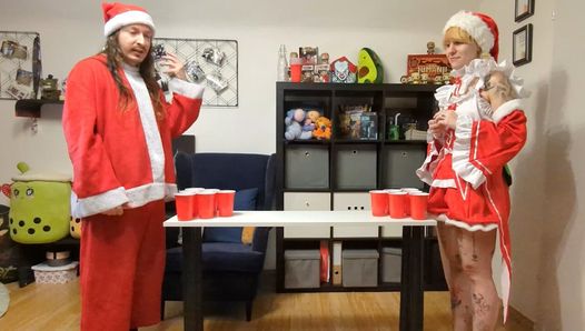 Blonde with big body tattoos playing strip games in a Santa outfit