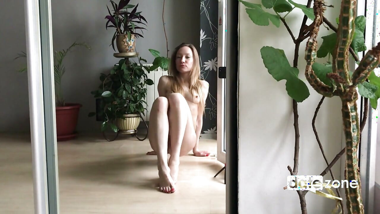 Amateur rides a dildo on the floor in front of the mirror