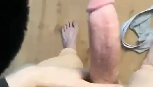 Mottled boy in a duckling T-shirt jerk off
