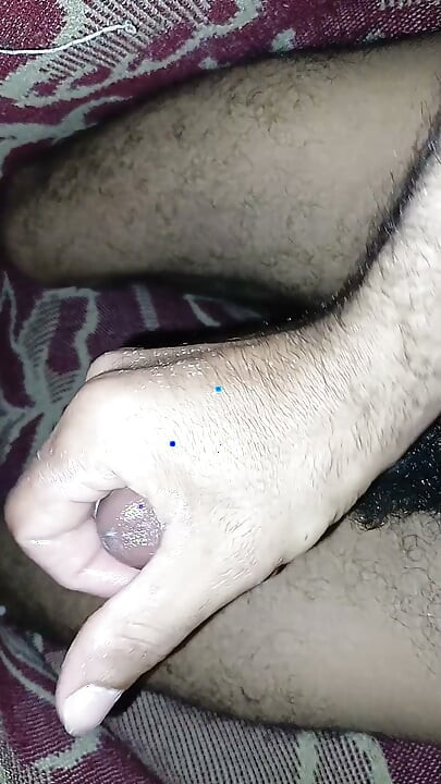 Handsome young man masturbating his large cock without a condom - twink with a big dick - stroking a black cock.