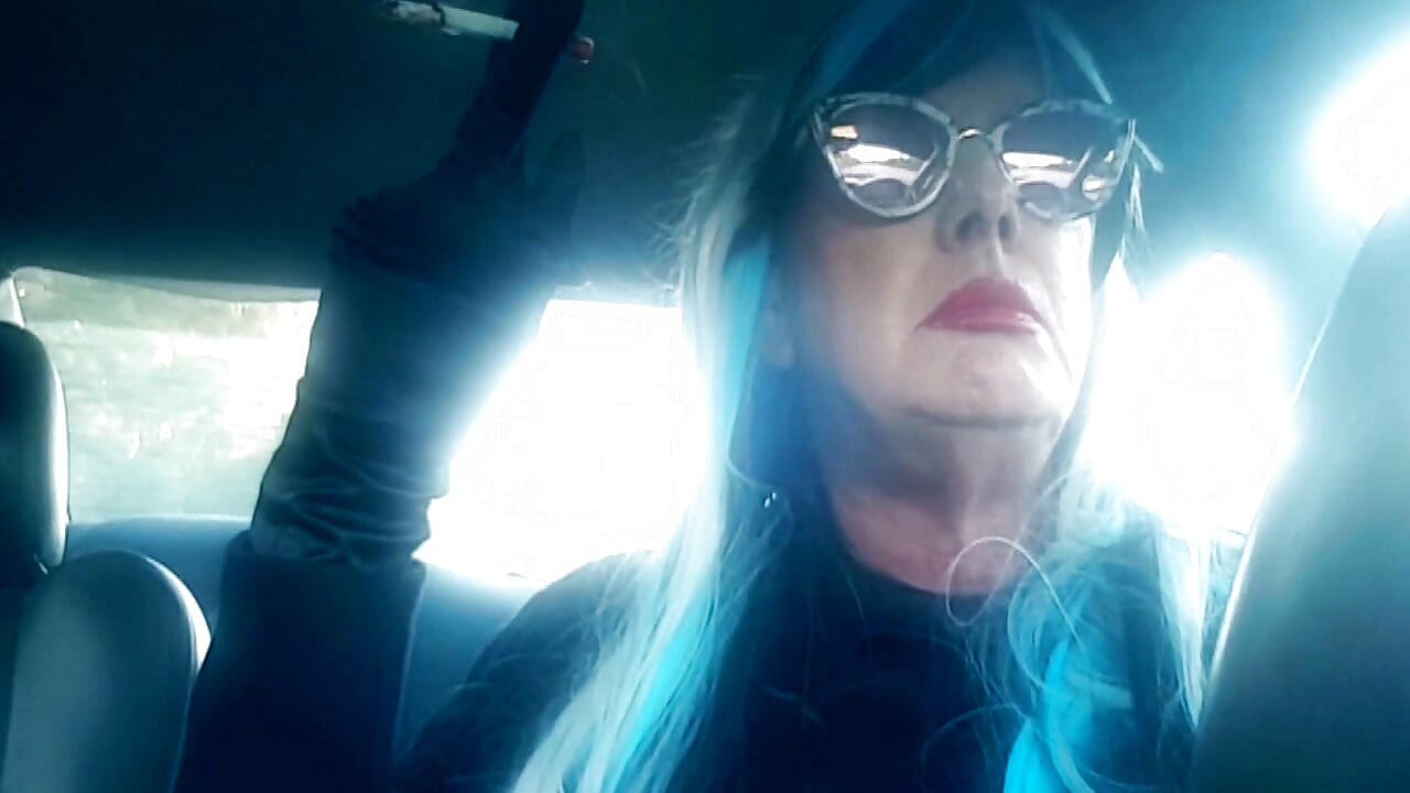 MATURE CD SMOKING & DRIVING WITH A MB100 CIGARETTE IN HER GLOVED HAND