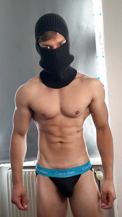 Young bodybuilder posing in a tight jock