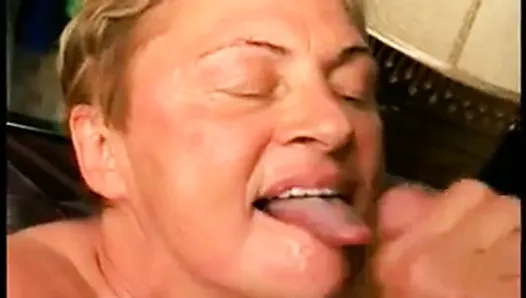 A fat old grandmother kneels and services a stiff cock