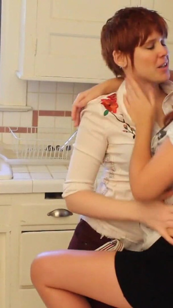 Unforgettable moment from "Short haired babe licks randy redhead's pussy in the kitchen"