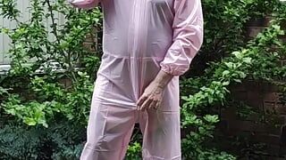 Tranny slut in pink PVC boiler suit outdoors