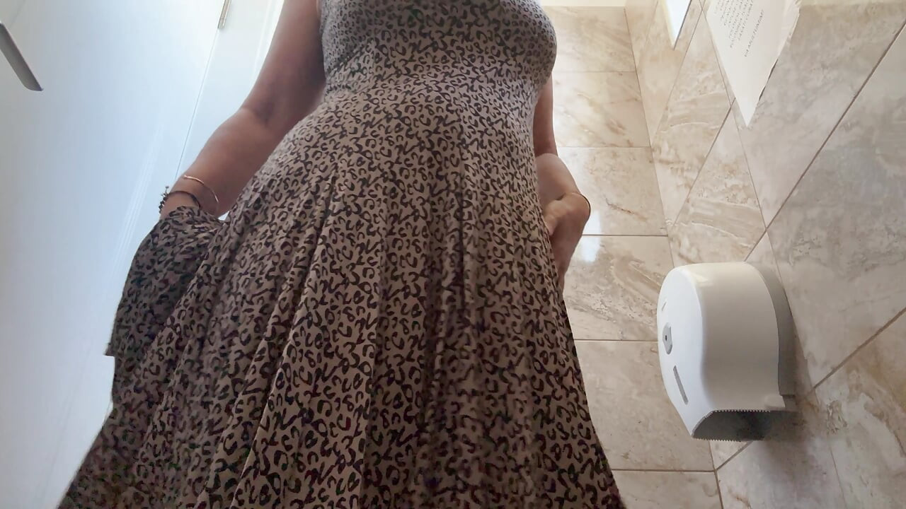 A horny mature MILF is very aroused and is rubbing her pussy in the public restroom at the office.