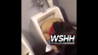Woman using men's urinal