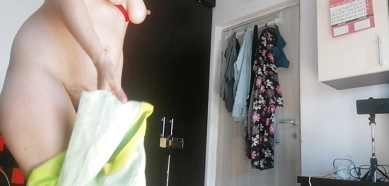 Amateur woman has fun trying on clothes and cutting them.