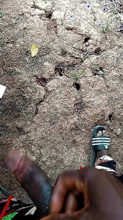 An African adult man masturbating inside the bush with his big dick