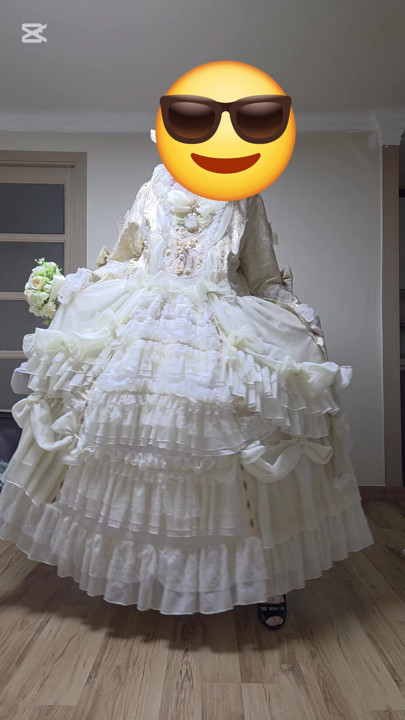 A man dressed as a woman dances in a dress.