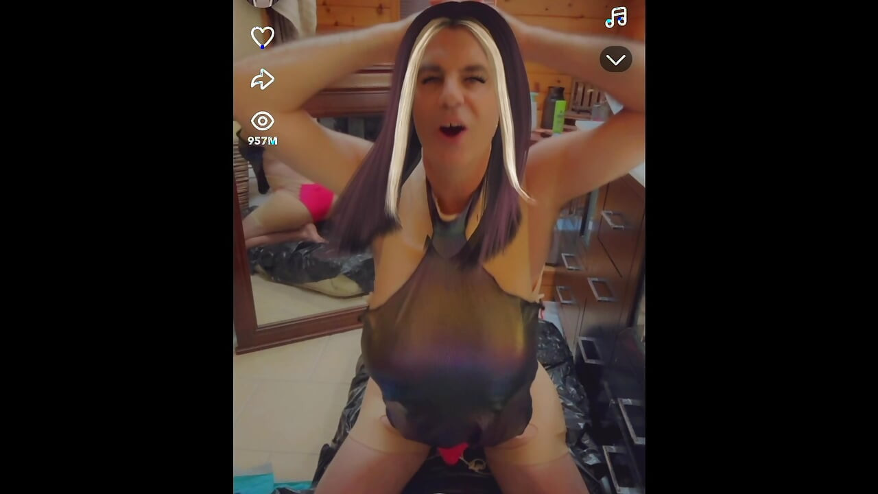 Sexy shemale wears shiny metallic halter top while masturbating