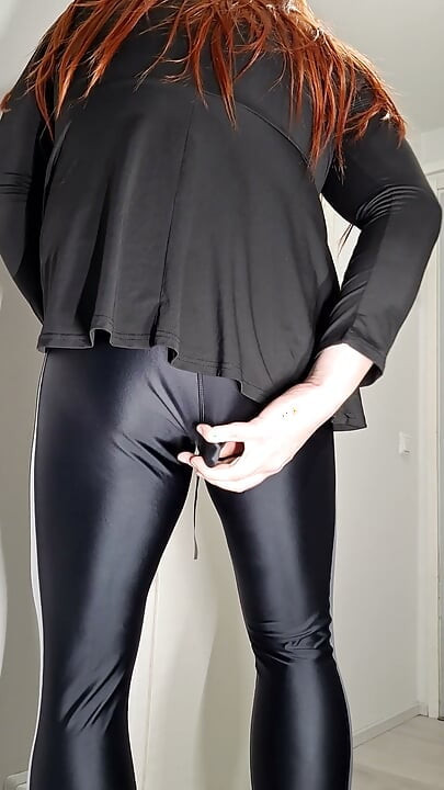 Crossdresser in shiny leggings enjoys toy