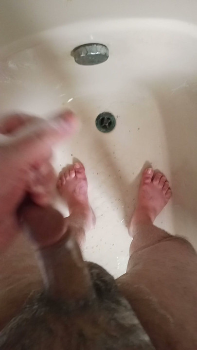 Sexy man with a large penis taking a shower