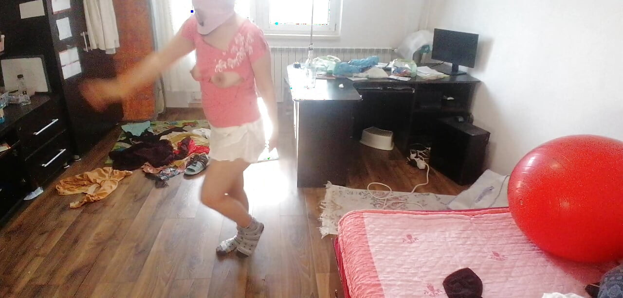 Amateur woman has fun trying on clothes and cutting them.