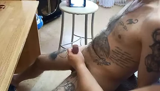 I'm sitting in a chair and my dick is being jerked off