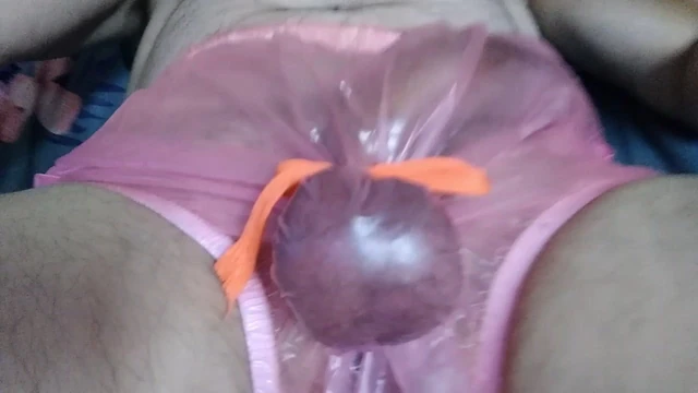 Bad boy in rubber pants gets ball beaten with a wooden spoon