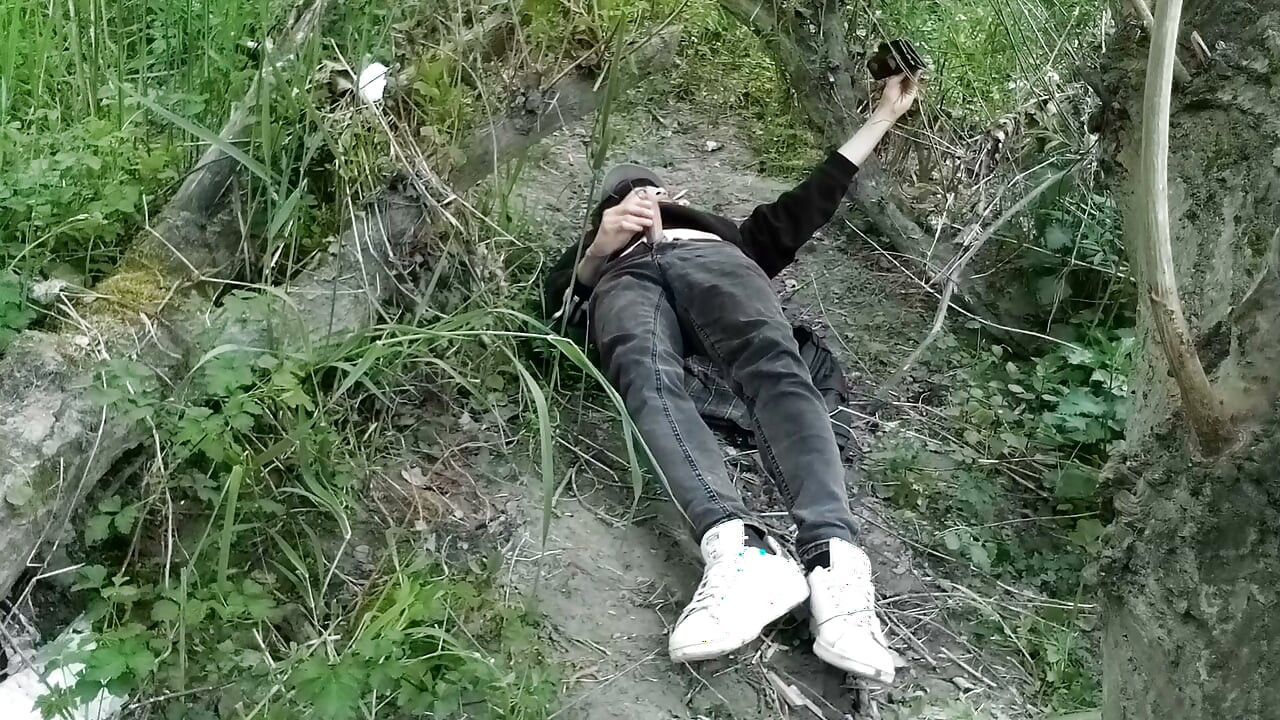 This gay twink sticks his cock through his fly to jerk off outside