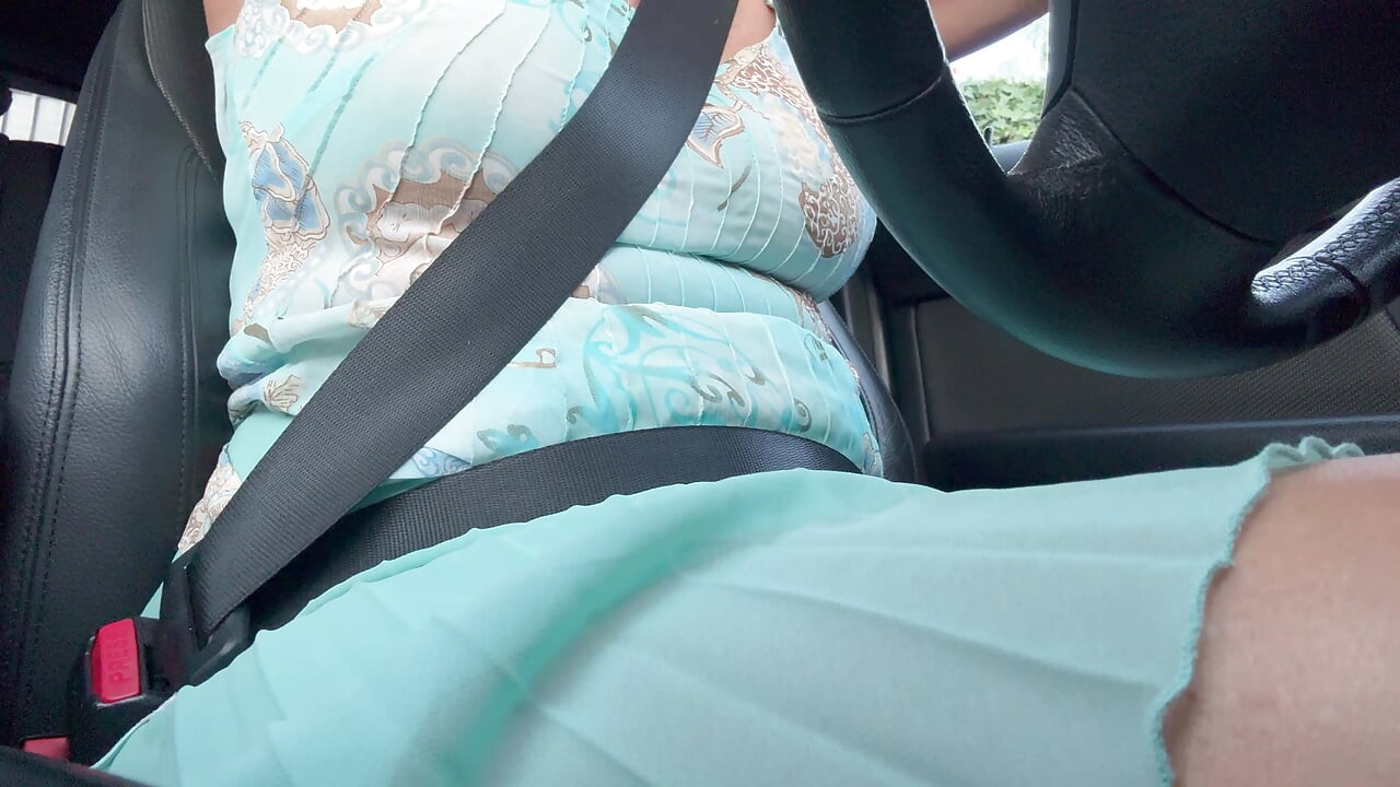 An elegant lady drives to work and rubs her pussy with her hand between her hot thighs