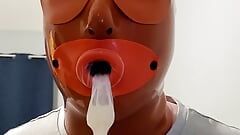 Sissy with Latex Hood Swallows Cum from Condom