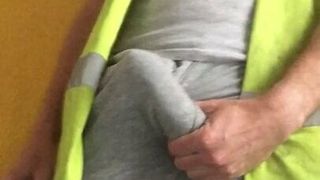 Tradesman uses hi vis vest as cumrag