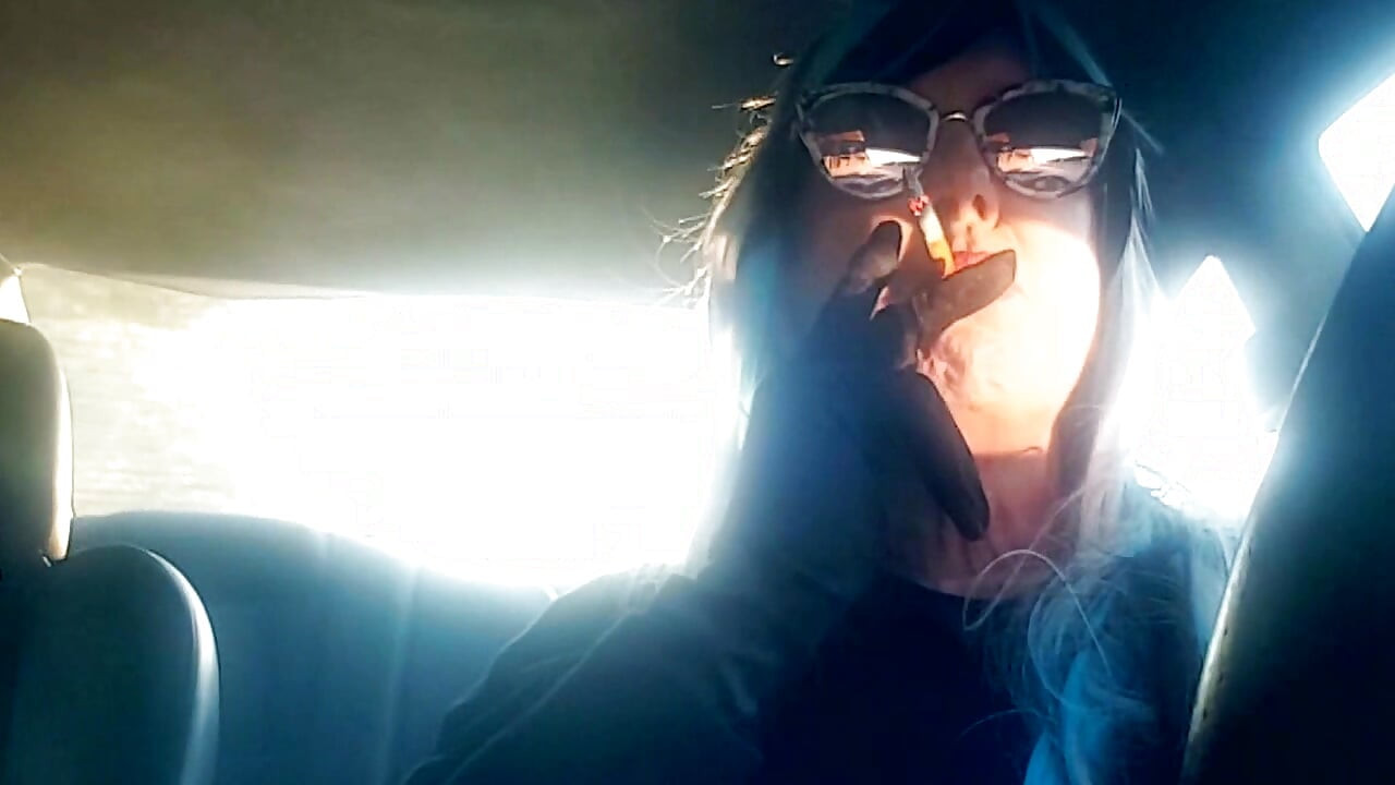 MATURE CD SMOKING & DRIVING WITH A MB100 CIGARETTE IN HER GLOVED HAND