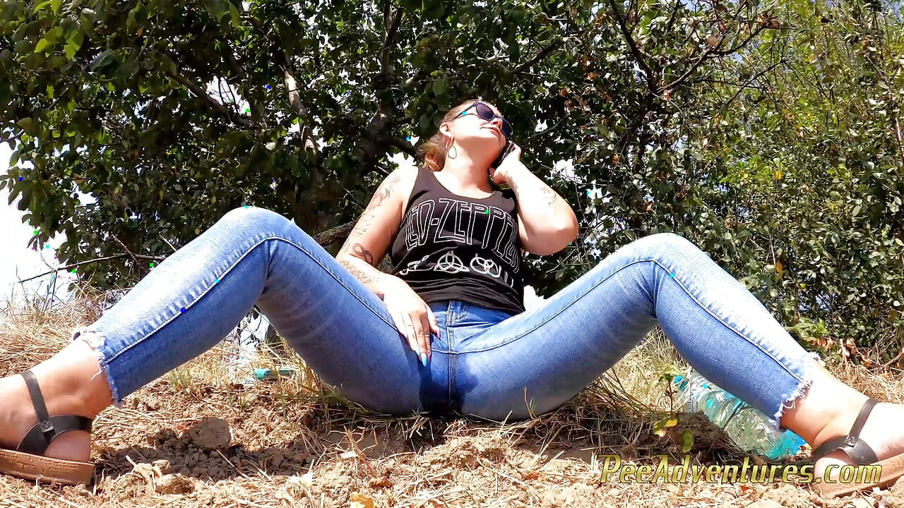 Chubby girl talking on the phone with her boy friend pee in her jeans