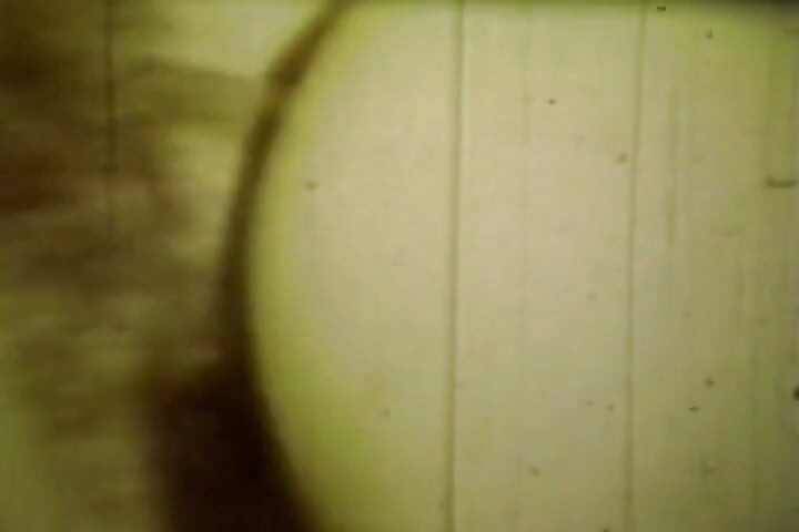 Worn Sepia Loop Captures Curly Retro Couple in Raw Bedroom Passion